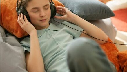 Child listening quietly with headphones